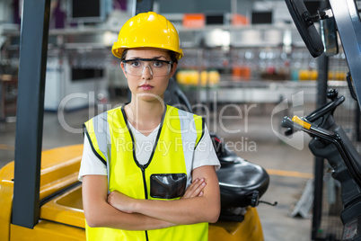 Portrait of female worker standing with arms crossed