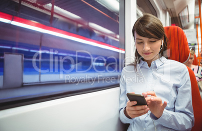Executive using mobile phone while listening music