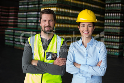 Factory workers standing with arms crossed in factory