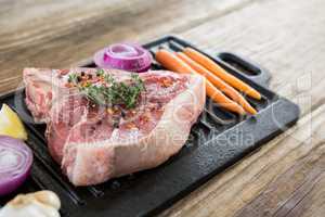 Sirloin chop and ingredients on grill tray