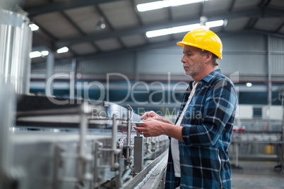 Factory worker monitoring production line