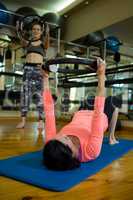 Determined women exercising with pilates ring