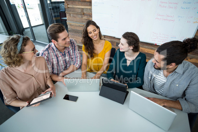 Business executives discussing with each other in meeting