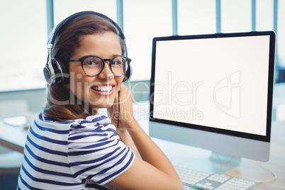 Female graphic designer working with headphones