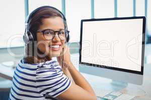 Female graphic designer working with headphones