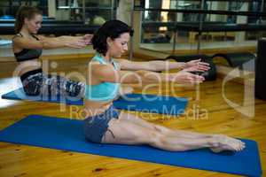 Fit women performing stretching exercise