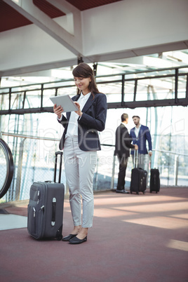 Businesswoman using digital tablet on platform