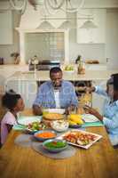 Family having meal on dinning table at home