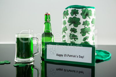 Green beer with shamrock, leprechaun hat and placard of St Patricks Day