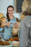 Female staff receiving a payment from customer at counter