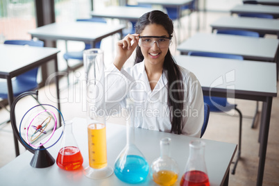 Portrait of schoolgirl sitting in laboratory