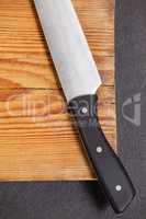 Knife on wooden board