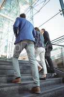 Business executives walking on stairs outside platform