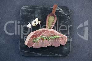 Sirloin chop, spics and garlic on slate plate