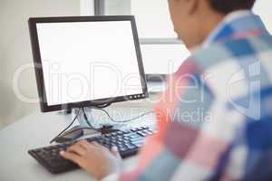Close-up of schoolboy using computer