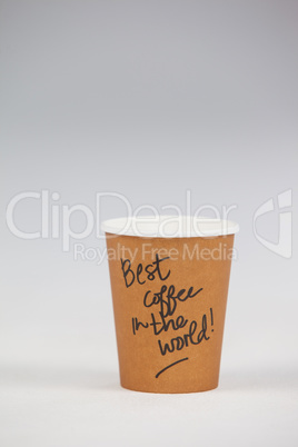 Disposable coffee cup with written text on white background