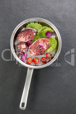 Sirloin chops and ingredients in frying pan