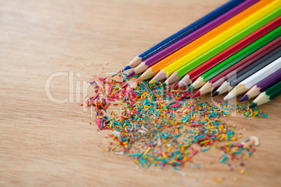 Colored pencils arranged in diagonal line with pencil shavings