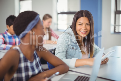 Students interacting with each other in classroom