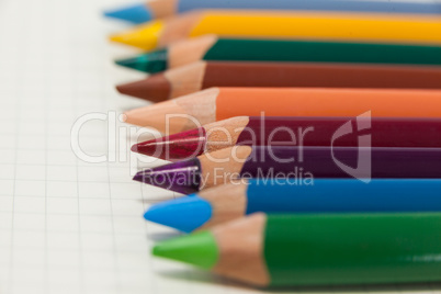 Close-up of colored pencils arranged in a row