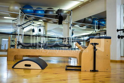 Various gym equipments on wooden floor