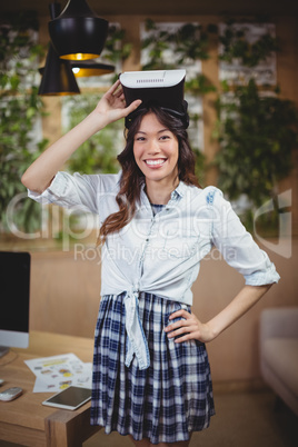 Portrait of female executive using virtual reality headset