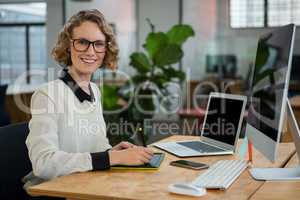 Female graphic designer sitting at desk