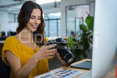 Graphic designer looking at pictures in digital camera