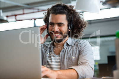 Executive using laptop in creative office