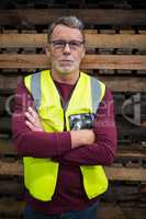 Portrait of male factory worker standing with arms crossed