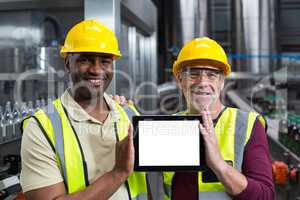 Portrait of factory workers holding digital tablet in the plant
