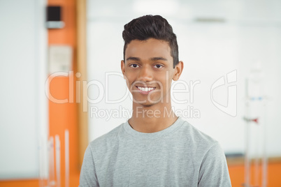 Portrait of smiling schoolboy in classroom