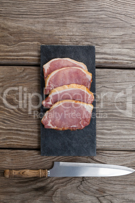 Sirloin chop on black slate plate with knife