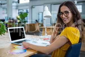 Female graphic designer working at desk