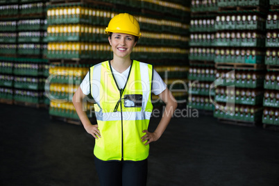 Portrait of female worker standing with hand on hip