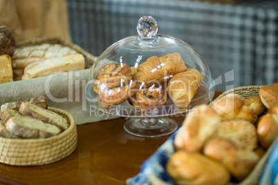 Close-up of croissants on cake stand at counter