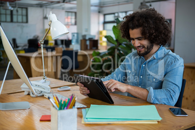 Graphic designer using digital tablet in creative office