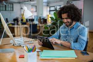 Graphic designer using digital tablet in creative office