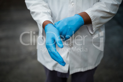 Factory engineer wearing gloves in bottle factory