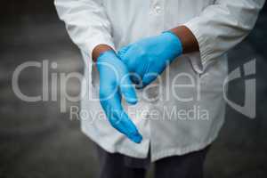 Factory engineer wearing gloves in bottle factory