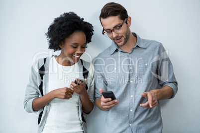 Man and woman using mobile phone