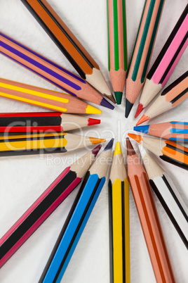 Close-up of colored pencils arranged in a circle