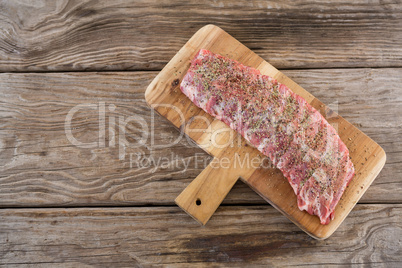 Beef ribs on wooden tray against wooden background