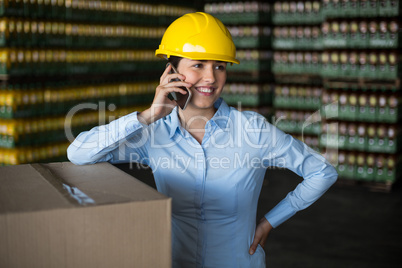 Female factory worker talking on mobile phone