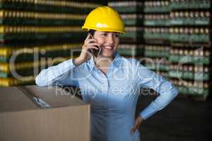 Female factory worker talking on mobile phone