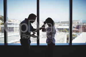 Business couple arguing near the window