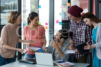 Colleagues interacting with frustrated man