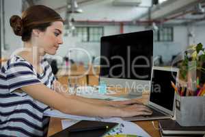 Female graphic designer using laptop