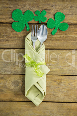 St Patricks Day fork and spoon wrapped in napkin with shamrocks