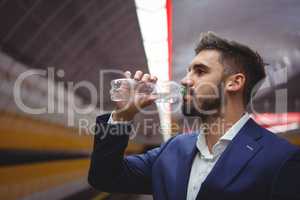 Business executive drinking water